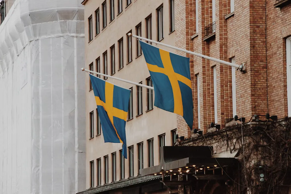 Swedish flags hanging from a building facade