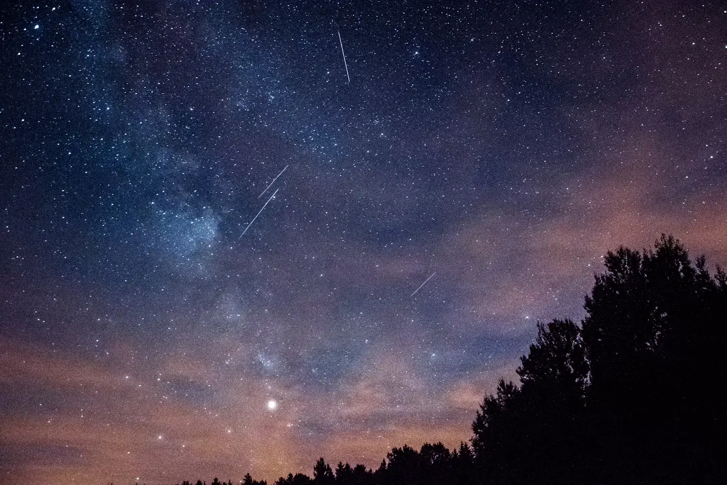 Perseid meteors streaking across a dark night sky